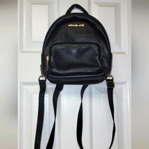 Micheal kors small black leather bookbag or crossbody bag with adjustable straps